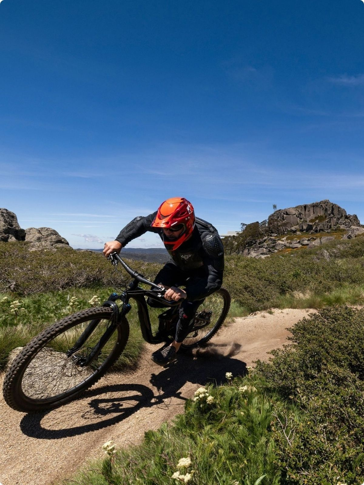 Mountain bikers riding alpine trails at Thredbo Mountain Bike Park.