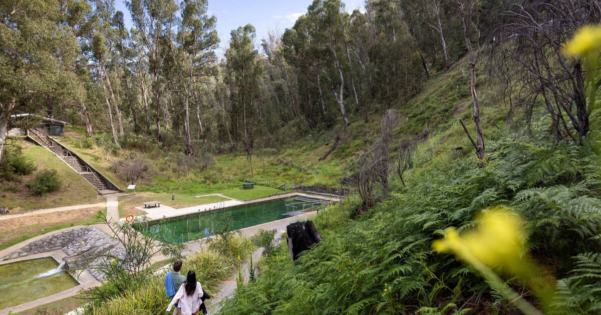 Couple explores the Yarrangobilly Caves Thermal Pool; Yarrangobilly, Snowy Mountains