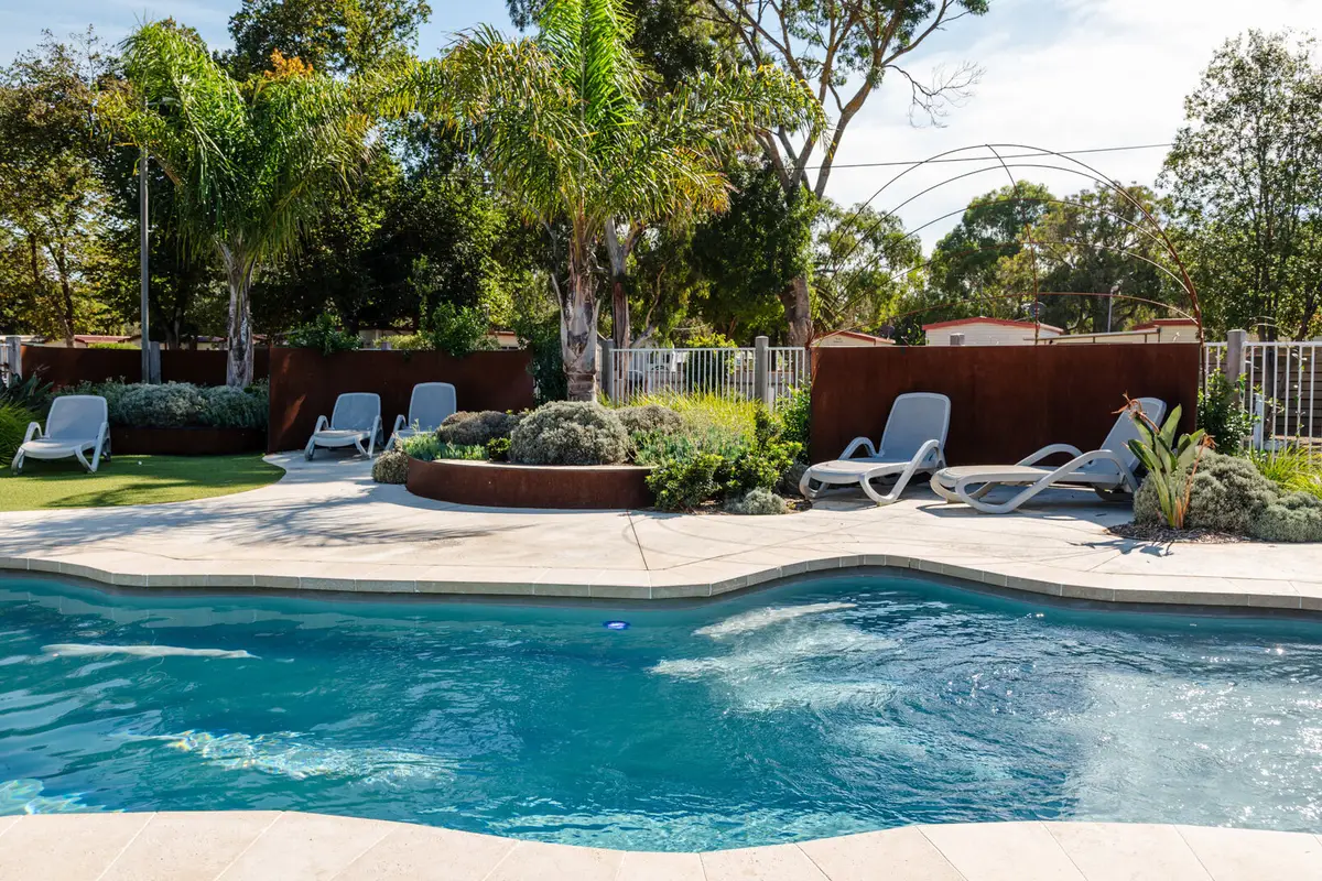 Lagoon style swimming pool surrounded by landscaped gardens at Geelong Holiday Park.