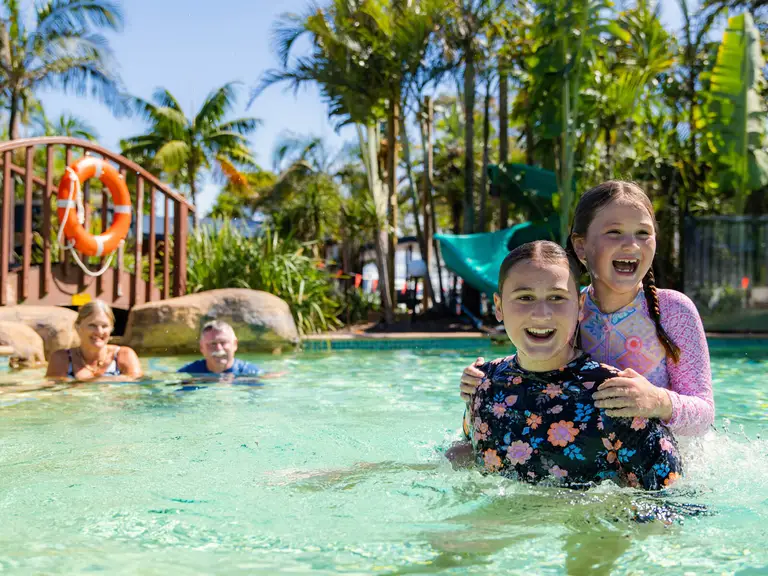Family enjoying a relaxed day swimming in the pool at family-friendly BIG4 Manning Point Holiday Park.