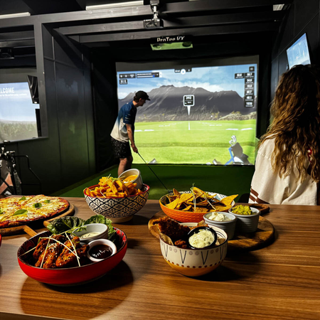 Mexican food served at The Mad Mexican restaurant in Batemans Bay with Patrons playing the golf simulators in the background.