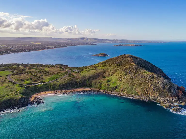 Aerial view of The Bluff (Longkuwar), or Rosetta Head, overlooking the blue waters of Encounter Bay at Victor Harbor, South Australia.