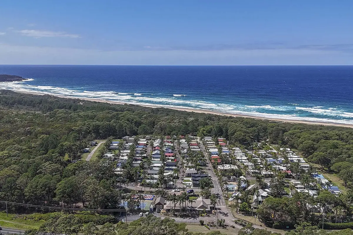 Aerial view of Wairo Beach Holiday Park beside Wairo Beach on the NSW South Coast.