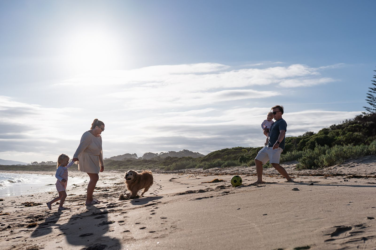 Family and dog enjoying Barlings Beach near the holiday park in Tomakin
