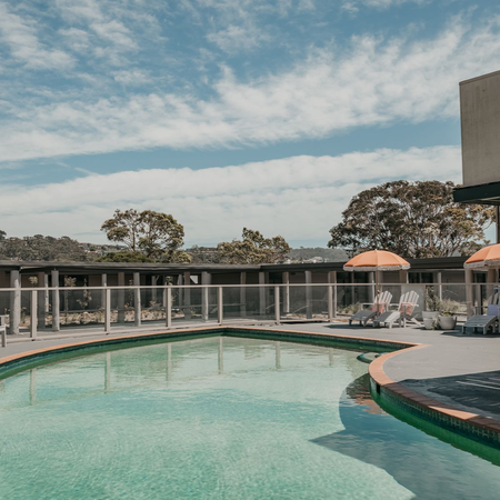 Black Dolphin Motel: outdoor swimming pool with surrounding poolside seating
