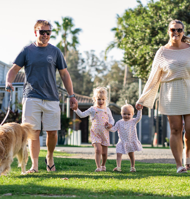 Family walking with their dog during a pet-friendly stay at Barlings Beach Holiday Park